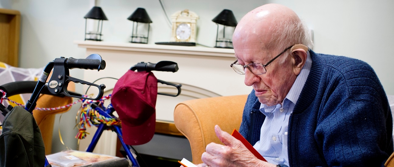 An elderly man reading a book