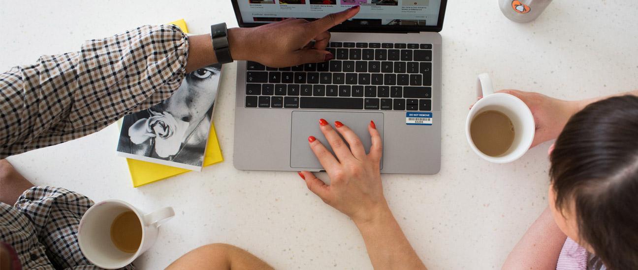 Three colleagues sitting around a computer