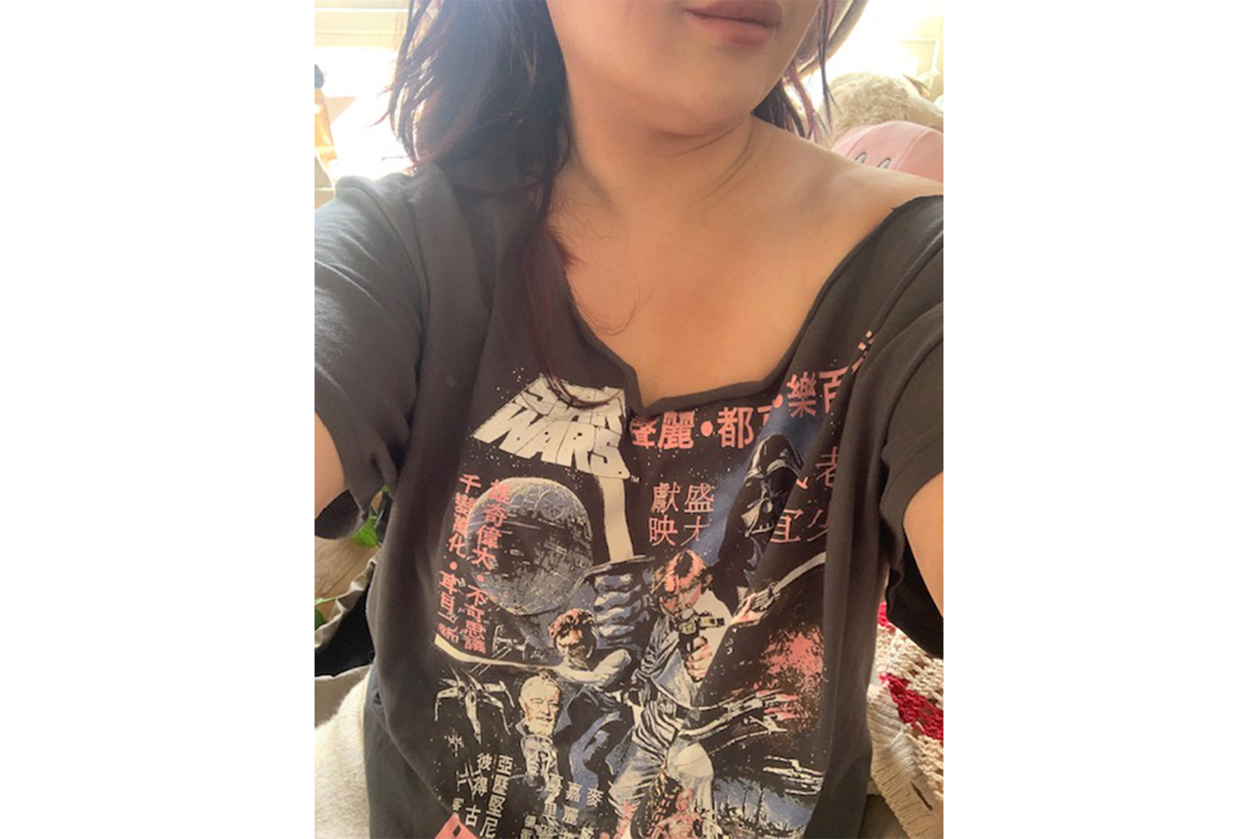 An image of a fan wearing a Chinese Star Wars graphic T-shirt