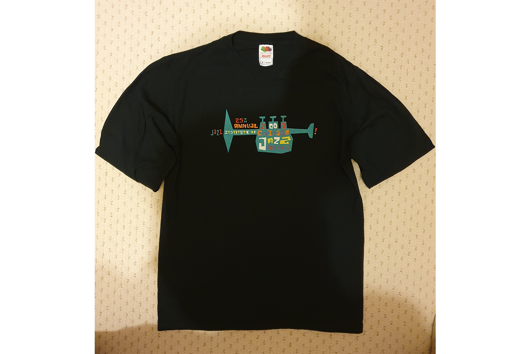 A fan's black T-shirt with a trumpet image on it, representing a Chicago Jazz Festival event