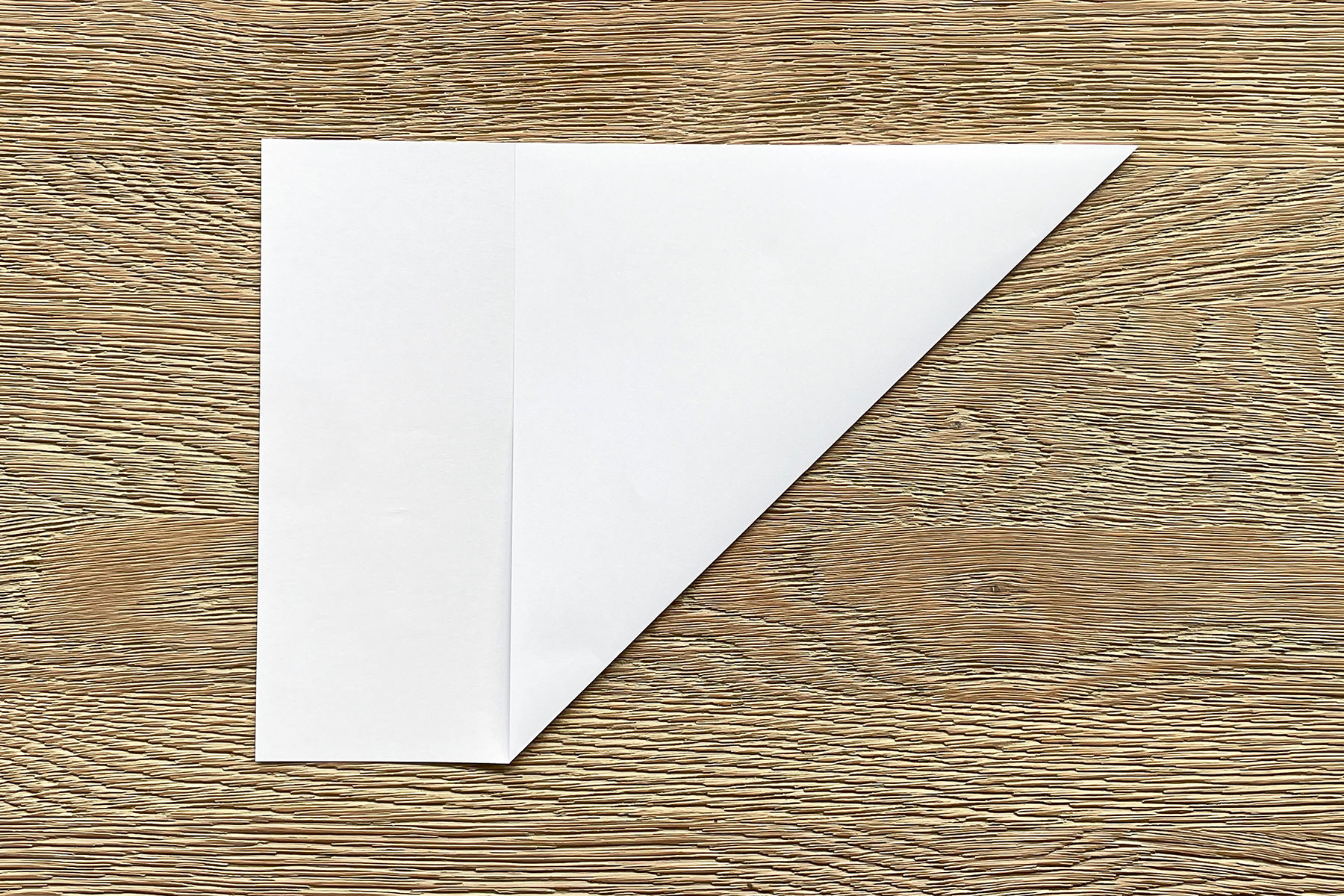 A photo of a piece of white A4 paper that has been folded to turn it into a square
