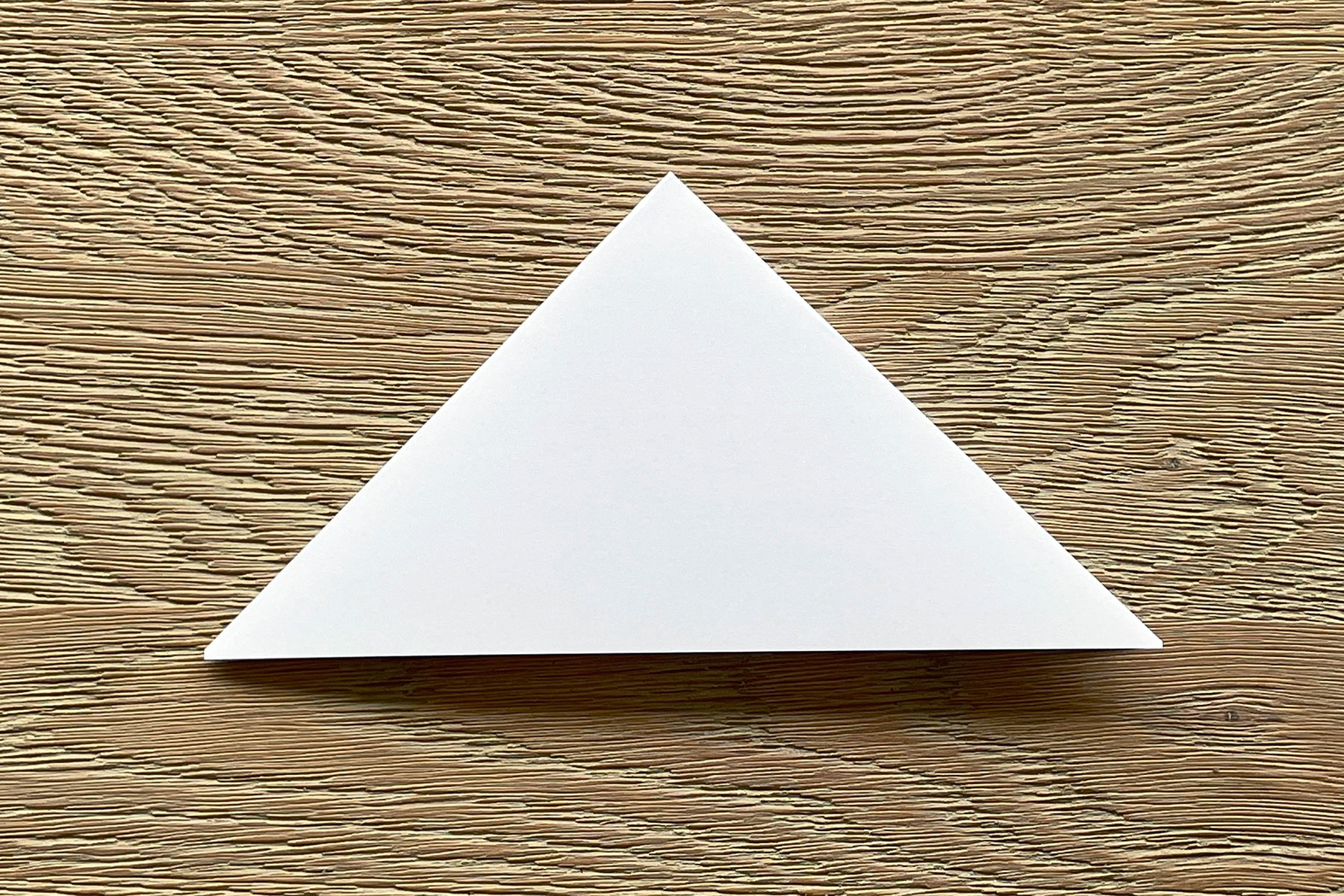A photo of a square piece of paper that has been folded diagonally